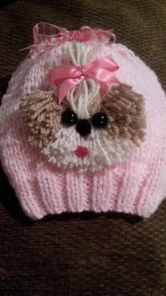 a knitted hat with a teddy bear on it