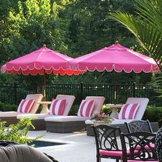 lounge chairs and umbrellas are set up on the patio