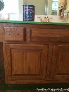 a can of diy paint sitting on top of a wooden cabinet in a bathroom