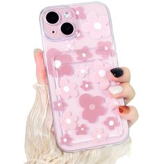 a woman holding a pink phone case with flowers on it