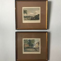 two framed pictures hanging on the wall next to each other