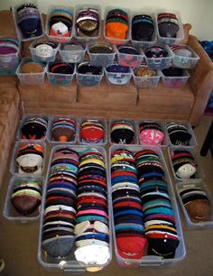 a room filled with lots of different types of hats and socks in plastic bins