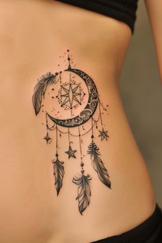 a woman's stomach with a crescent and stars tattoo on the side of her belly