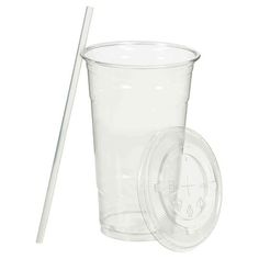 a plastic cup with a straw in the middle and a lid on it, next to a