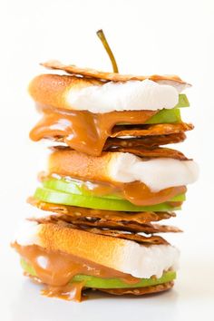 a stack of apple slices covered in caramel and marshmallows, stacked on top of each other