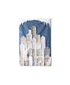 a paper cut out of buildings with snow on the roof and trees in the background