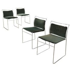 three green chairs sitting next to each other on a white surface with no one in them