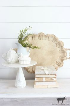 a white table topped with books and vases