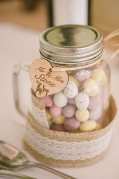 a mason jar filled with mini eggs on top of a table