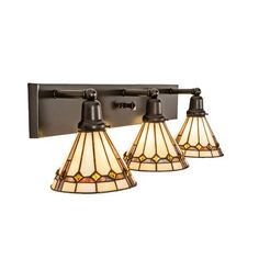 three light bathroom fixture with stained glass shades on the side and an old fashioned metal arm