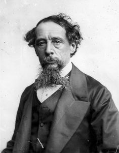 an old black and white photo of a man with a long beard wearing a suit