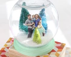 a snow globe with family photos in it