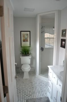 a white toilet sitting in a bathroom next to a walk in shower