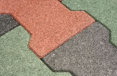 the floor is made up of different colors and shapes, including black, gray, red, green, orange