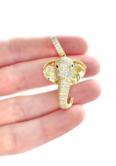 - 18K Gold plated over 925 silver elephant head pendant iced out with cubic zirconia stones - Pendant dimensions: 1 3/8" height, 7/8" width - Pendant has a good weight and is very shiny, with the elephant ears having a shiny polished finish - Ganesha the Hindu elephant god symbolizes protection and the removal of obstacles from one's path Hindu Elephant, God Pendant, Elephant God, Good Luck Charms, Lover Jewelry, Silver Elephant, Gold Elephant, Silver Elephants, Elephant Ears