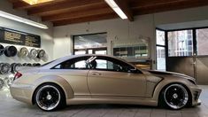 a car parked in a showroom next to some tires