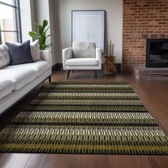 a living room with two white couches and a rug in front of a fireplace