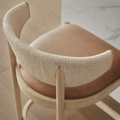 a close up of a wooden chair with a cushion on it's backrest