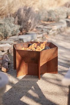 a fire pit sitting on top of a sandy ground