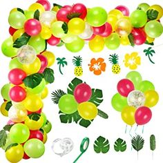 a bunch of balloons and decorations for a tropical themed party