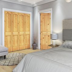 a large bed sitting in a bedroom next to two wooden doors