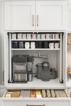 white custom kitchen featuring the perfect coffee cabinet with a pot filler for easy filling every morning and a coffee storage drawer below. L Shaped Kitchen With Coffee Bar, Narrow Coffee Station, Pot Filler For Coffee Bar, Integrated Coffee Station, Pot Filler Coffee Bar, Coffee Bar Pot Filler, Coffee Appliance Garage, Coffee Bar With Pot Filler, Coffee Bar In Pantry Closet