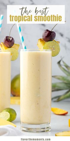 two glasses filled with smoothie next to sliced fruit