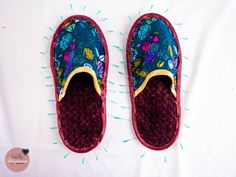 a pair of shoes that are on top of a white sheet with blue and yellow sprinkles