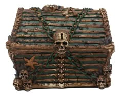 a wooden box with skulls and chains on the front, sitting on a white surface