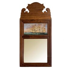 a mirror with a ship painted on the side of it and an image of a sailboat