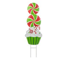 a green cupcake with candy canes on top