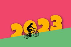 a man riding a bike on top of a green and pink hill with the year 2013 written in yellow