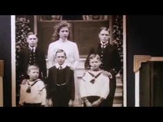 an old black and white photo of children in front of a door with their parents