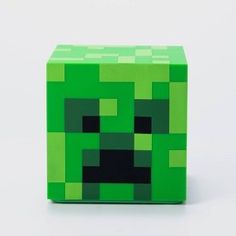 an image of a green creeper block with black eyes on the front and bottom