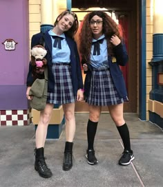 two girls in school uniforms posing for the camera