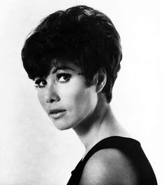 a black and white photo of a woman with short hair