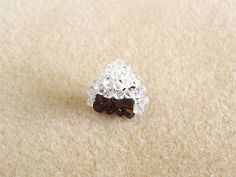 a white and brown ring sitting on top of a carpet