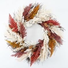 a wreath made out of dried flowers and leaves