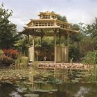 a gazebo sitting on top of a lush green field next to a body of water