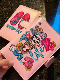 someone is holding up a pink wallet with the words hello kitty and shoes on it