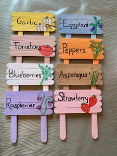 four popsicles with different types of vegetables painted on them and labeled in the words