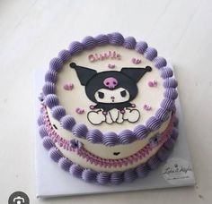 there is a decorated cake on top of the table with pink and purple icing