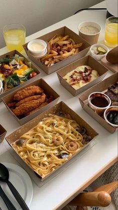 there are many different types of food in boxes on the table with utensils