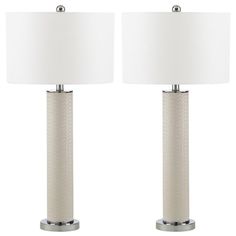 a pair of table lamps with white linen shades on each lamp and one light in the middle