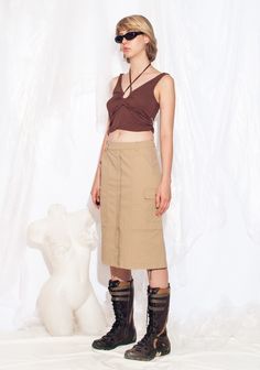 Y2K vintage cargo skirt. Made from cotton, this minimalist skirt comes in beige with four pockets to stash all your goodies. With a zip closure and 2000s vibes, it's the buttery-soft swag you need. Our model, Szonja is 173 cm / 67.5" tall and she's a size XS. Size: XS / US 2 / UK 6 / IT 38 Other size info: Labelled size: 34 Measurements:  waist: 72 cm / 28.1" length: 62 cm / 24.2" Fabric: cotton 97%, elastane 3% Care: Machine wash inside out Beige Cotton Cargo Skirt With Pockets, Beige Cargo Skirt With Utility Style, Beige Utility Cargo Skirt, Khaki Cotton Cargo Skirt, Cargo Skirt, Style Expert, Label Sizes, Y2k Vintage, Hungary