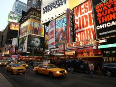 the times square in new york city is crowded with people and cars at night time