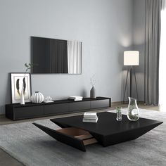 a modern living room with black furniture and large mirror on the wall above the coffee table