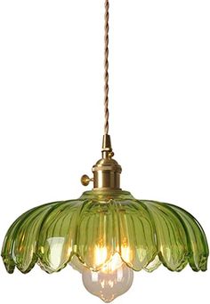 a green glass light hanging from a ceiling