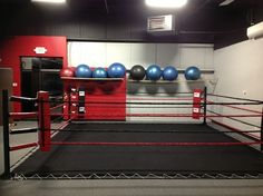 an empty boxing ring with blue and red balls