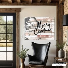 a black leather chair sitting in front of a wooden wall with a merry christmas sign on it